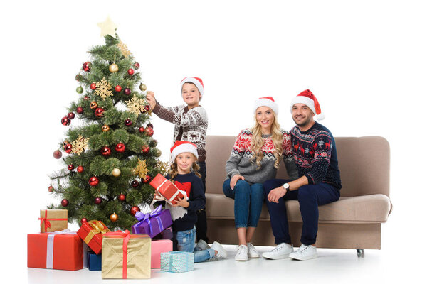 happy family with children near christmas tree with presents, isolated on white