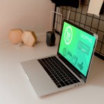 Close up view of digital laptop with shopping lettering on screen on tabletop at home