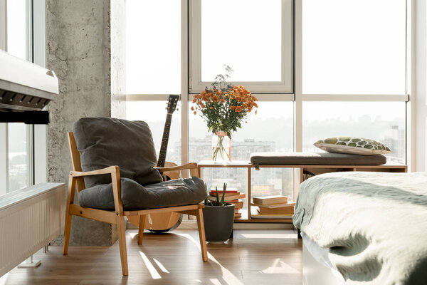 close up view of empty modern room interior with armchair at big window 