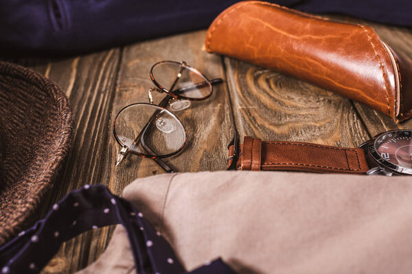 Крупный план расположения мужских аксессуаров на деревянном столе
