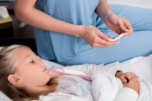 Cropped Shot Mother Checking Her Little Daughters Temperature Electric Thermometer — Stock Photo, Image