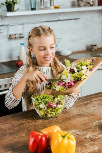 Smiling Little Child Pouring Sliced Lettuce Bowl Salad Kitchen — Stock Photo, Image