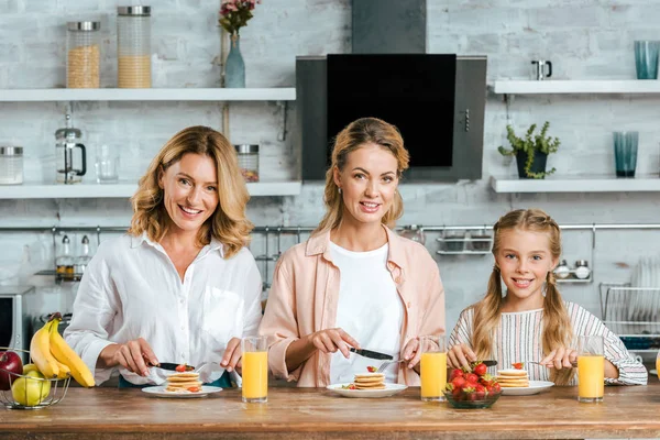 Beautiful Child Mother Grandmother Eating Pancakes Breakfast Home Looking Camera — Stock Photo, Image