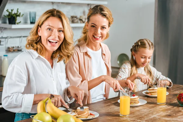 Happy Three Generations Women Having Pancakes Breakfast Home Looking Camera — Stock Photo, Image