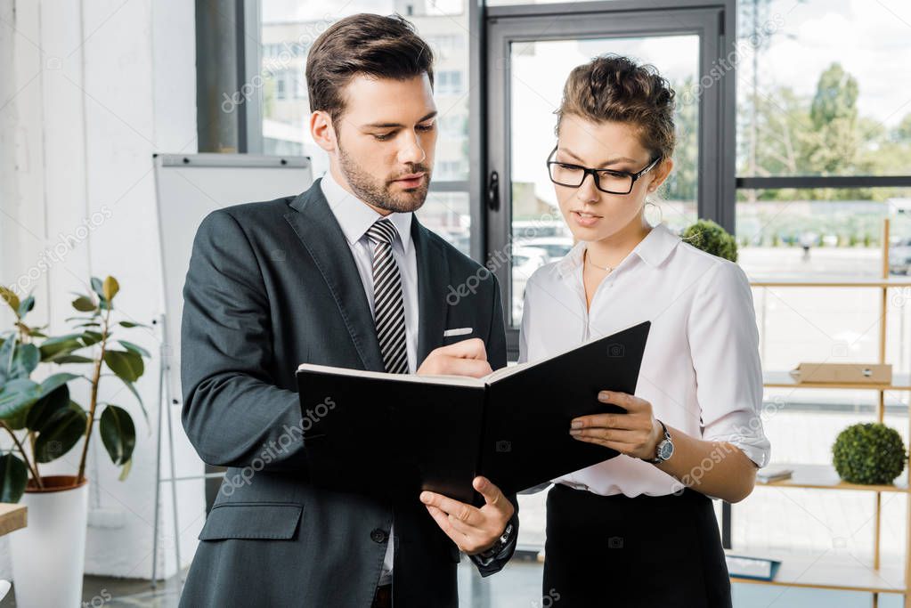 portrait of business colleagues signing papers in office