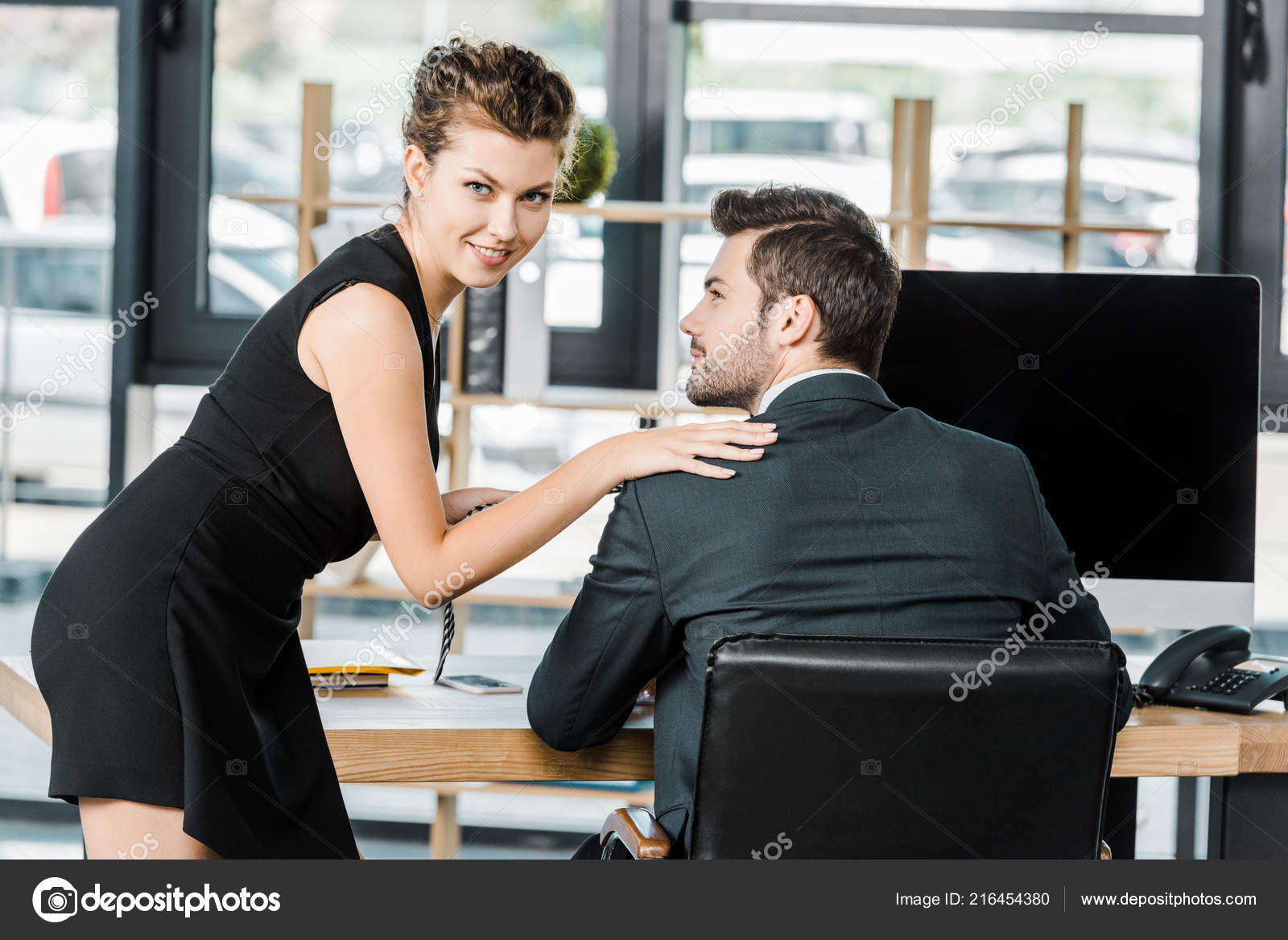 Young Businesswoman Holding Colleagues Tie While Flirting Workplace