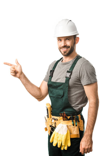 smiling handsome electrician pointing on something isolated on white