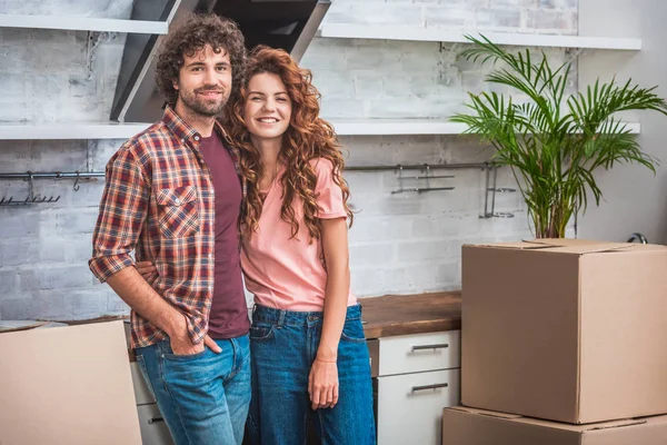 Smiling Couple Curly Hair Standing Cardboard Boxes Looking Camera New — Free Stock Photo