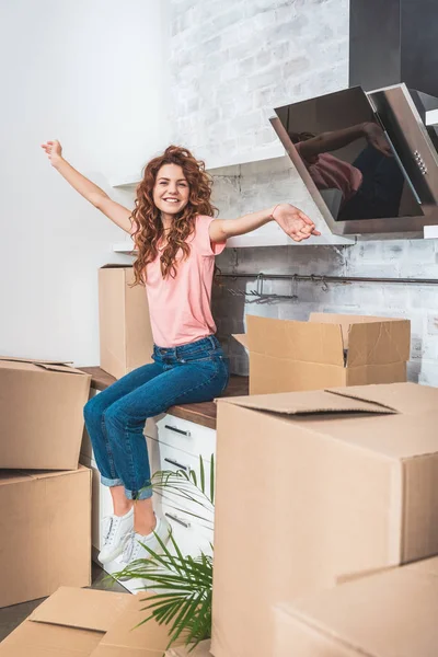 Mujer Atractiva Feliz Con Pelo Rizado Sentado Mostrador Cocina Con — Foto de stock gratuita