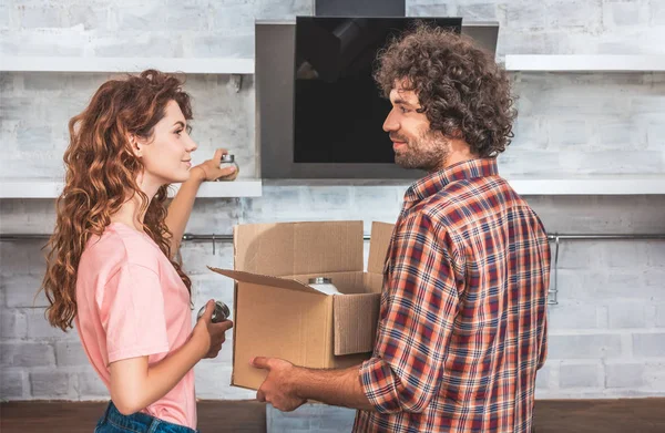 Side View Couple Taking Utensil Cardboard Box New Home Looking — Stock Photo, Image