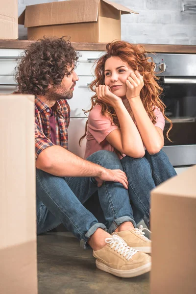 Cheerful Couple Sitting Floor Cardboard Boxes New Kitchen Looking Each — Stock Photo, Image