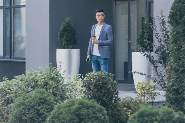 Handsome Asian Man Holding Coffee Smartphone Street — Free Stock Photo