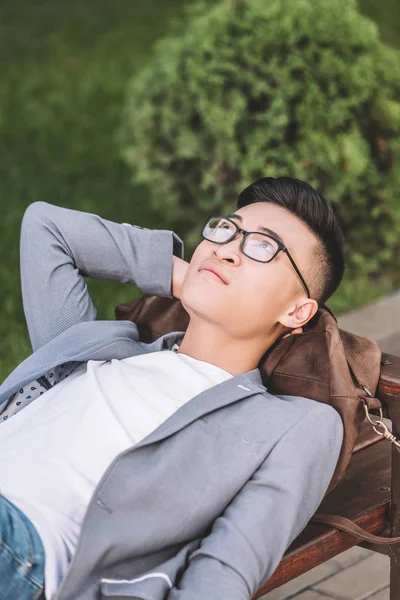 Handsome Thoughtful Asian Man Eyeglasses Dreaming Lying Bench — Stock Photo, Image