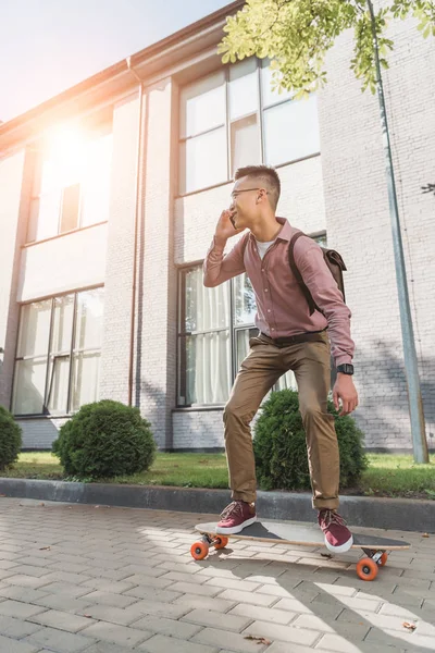 Asian Man Talking Smartphone While Standing Longboard Street — Stock Photo, Image