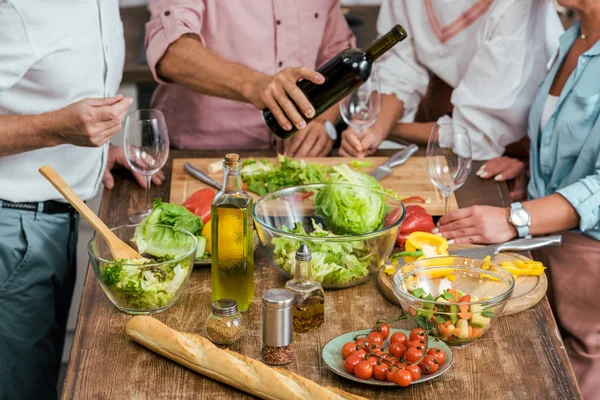 Cropped Image Man Pouring Wine Happy Old Friends Dinner Kitchen — Stock Photo, Image