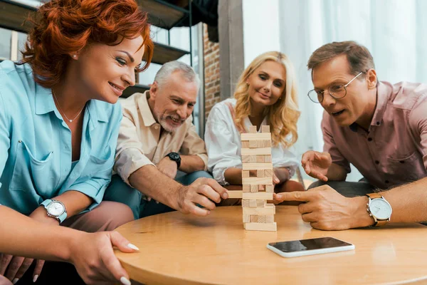 Happy Mature Men Women Playing Wooden Blocks Together Home — Stock Photo, Image