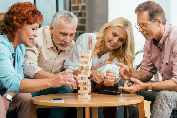 Two Mature Couples Playing Wooden Blocks Home — Stock Photo, Image