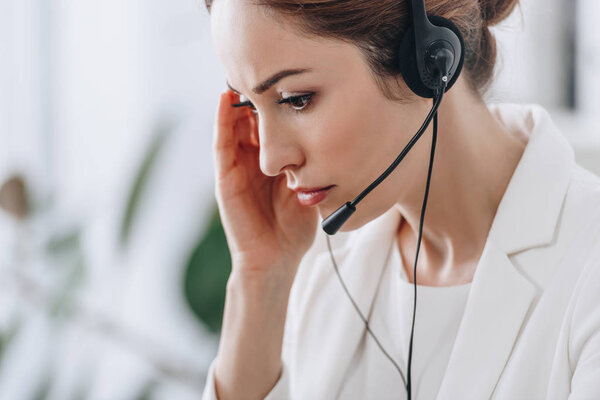 tired female support operator working with headset 