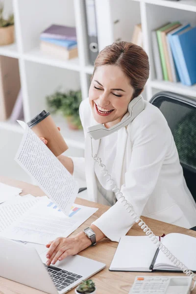 Laughing Businesswoman Holding Coffee While Talking Phone Working Documents Laptop — Stock Photo, Image