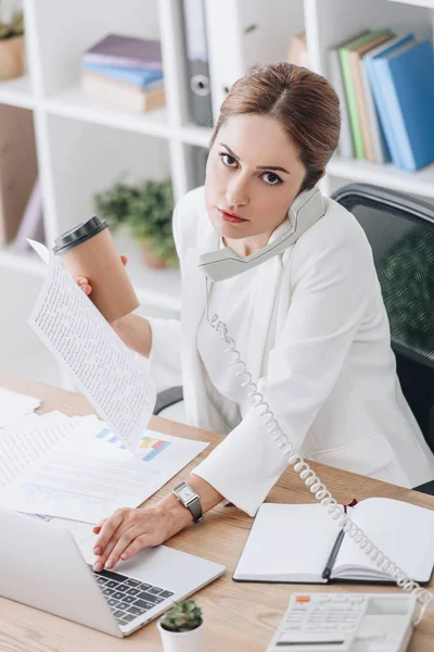 Confident Businesswoman Holding Coffee While Talking Phone Working Documents Laptop — Stock Photo, Image