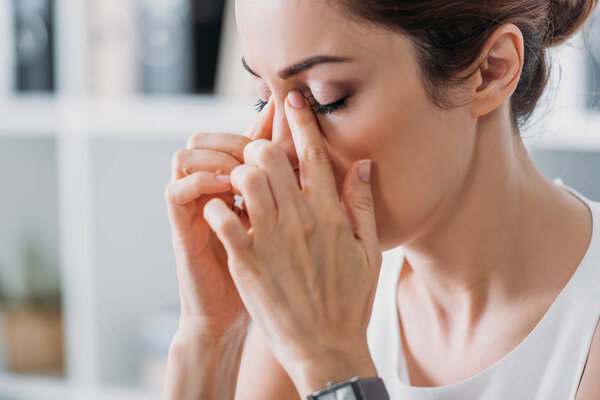 attractive tired businesswoman having headache