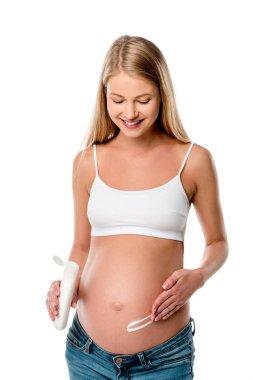 attractive pregnant woman applying lotion on her belly to avoid stretch marks isolated on white clipart