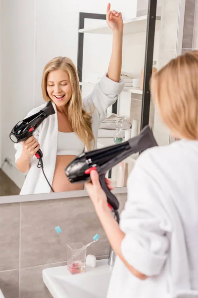 Attractive Happy Pregnant Woman Bathrobe Singing Hair Dryer Front Mirror — Stock Photo, Image