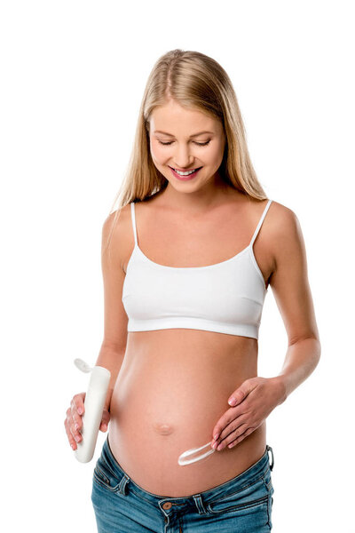 attractive pregnant woman applying lotion on her belly to avoid stretch marks isolated on white