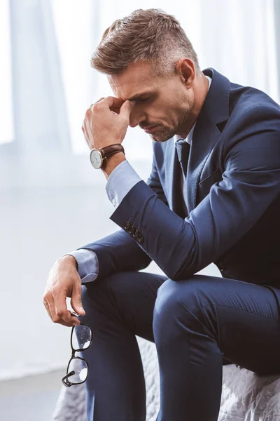 Tired Businessman Holding Eyeglasses Rubbing Nose Bridge While Sitting Bed — Stock Photo, Image