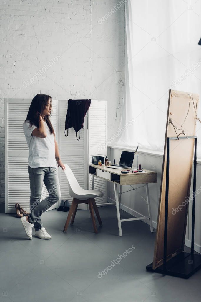 Young transgender woman spending time alone at home
