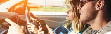 Kız arkadaşı için yön sürüş arabayı gösterilen smartphone ile gülümseyen adam