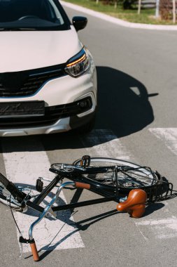 close up view of broken bicycle and car on road, car accident concept clipart