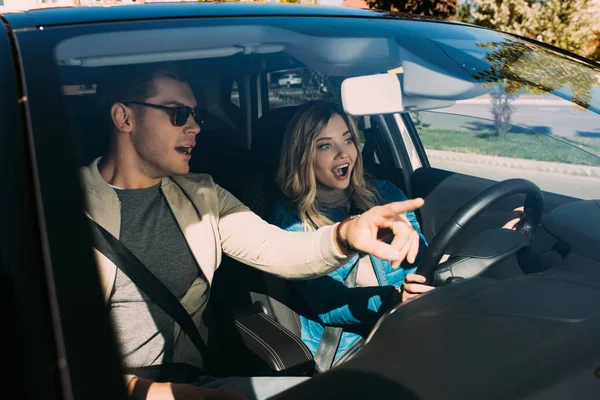 Emotional Man Pointing Way Girlfriend Drivers Seat Car — Stock Photo, Image