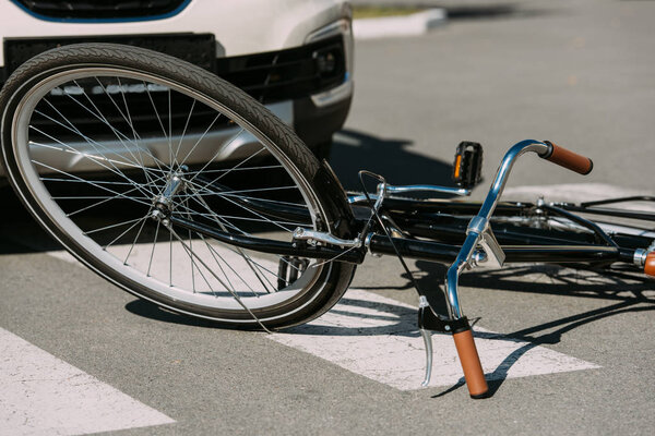 close up view of broken bicycle and car on road, car accident concept