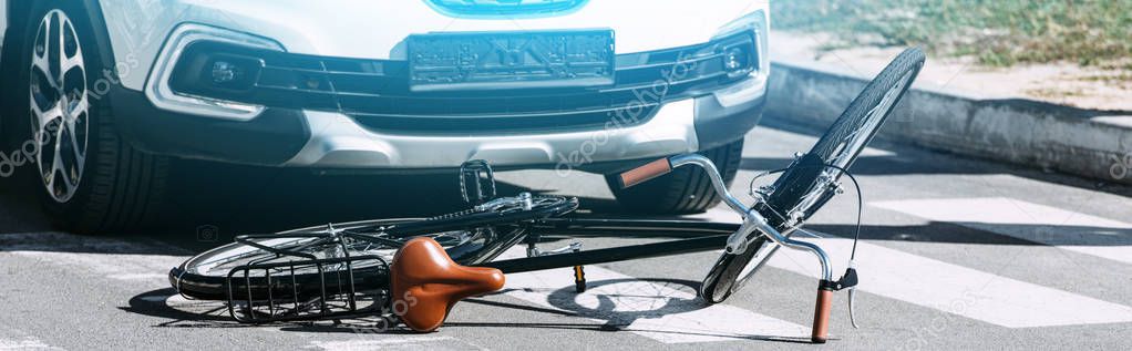 close up view of broken bicycle and car on road, car accident concept