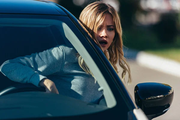 Young Shocked Woman Leaning Out Car Window While Driving Car — Stock Photo, Image