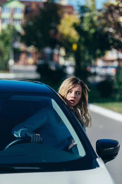 年轻的震惊女子在开车时靠在车窗外 — 免费的图库照片