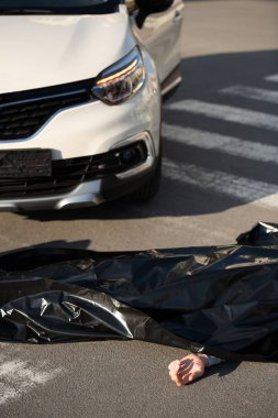 high angle view of corpse and car on road after traffic collision clipart