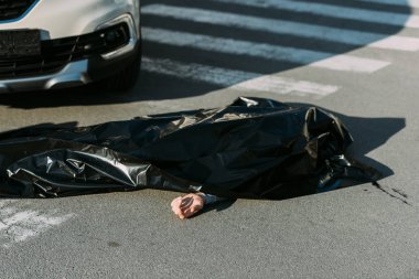 high angle view of corpse and car on road after traffic accident  clipart