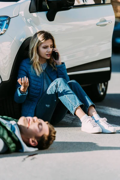 Asustada Joven Mujer Llamando Emergencia Mientras Hombre Herido Acostado Carretera — Foto de Stock