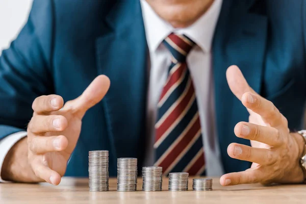 Hombre Negocios Agarrando Monedas Plata Mesa Madera —  Fotos de Stock