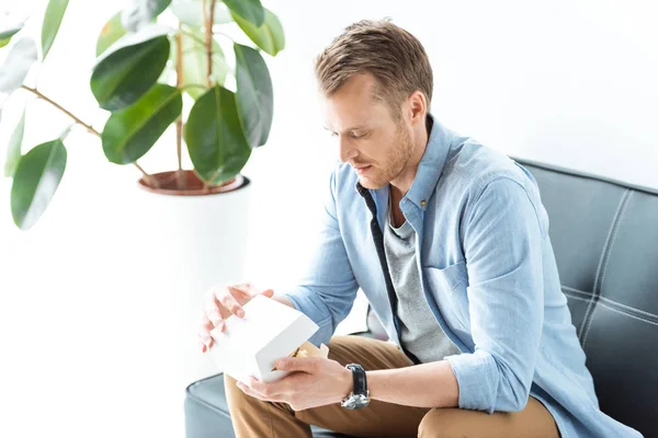 Selektiv Fokus För Ung Affärsman Lunch Med Burger Sittande Soffan — Gratis stockfoto