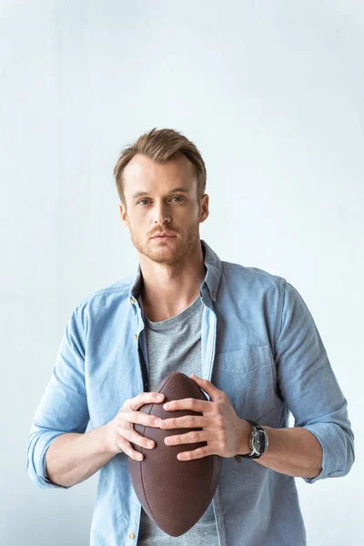 Young Serious Man Holding Rugby Ball Looking Camera Wall — Free Stock Photo