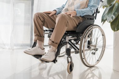 close up of senior man sitting in wheelchair in nursing home clipart