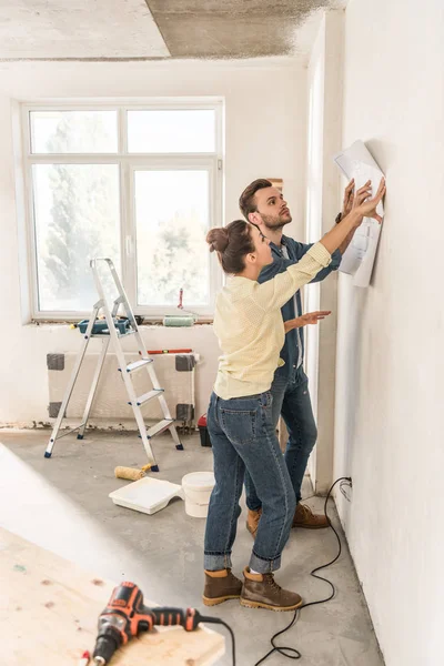Side View Young Couple Holding Blueprint Wall Renovation — Stock Photo, Image