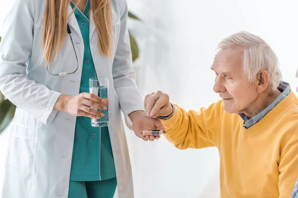 Joven Médico Mujer Dando Pastillas Hombre Mayor — Foto de Stock