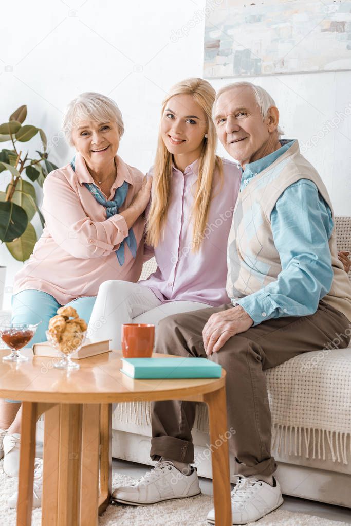 young woman spending time with senior parents