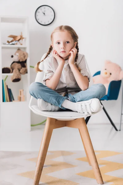 Lonely Little Child Sitting Chair Front Shelves Toys Looking Camera — Free Stock Photo