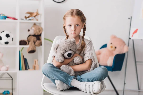 Lonely Little Child Sitting Chair Embracing Her Teddy Bear While — Stock Photo, Image