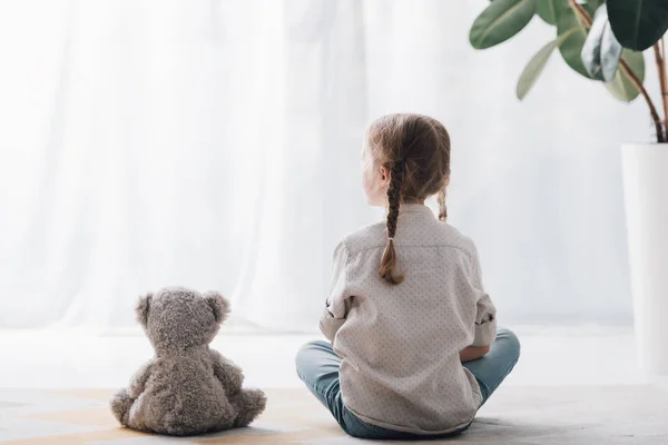 Rear View Little Child Sitting Floor Teddy Bear Looking Away — Stock Photo, Image